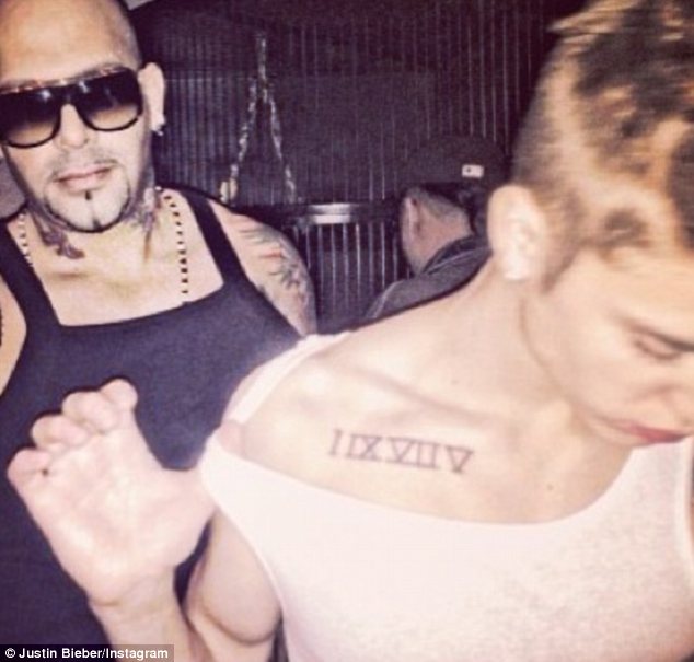 justin-s-roman-numeral-tattoo-on-his-chest-shoulder