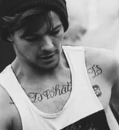 Louis Tomlinson shows off his tattoos in rocker tee as he steps